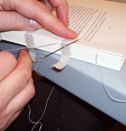 Abarca de la Fuente, Soledad. Valérie kettle-stitching signatures together, 2005, Toronto.